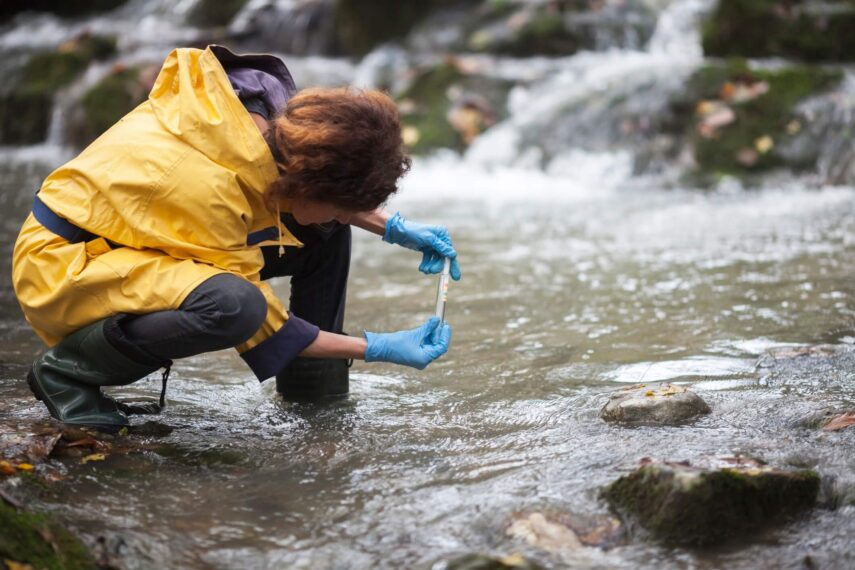 Woman testing water quality at river